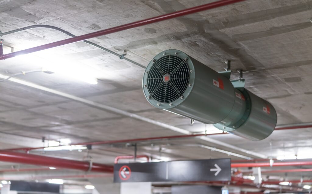 Jet fan at underground parking area. Ventilation fan in the parking lot. Air flow system.